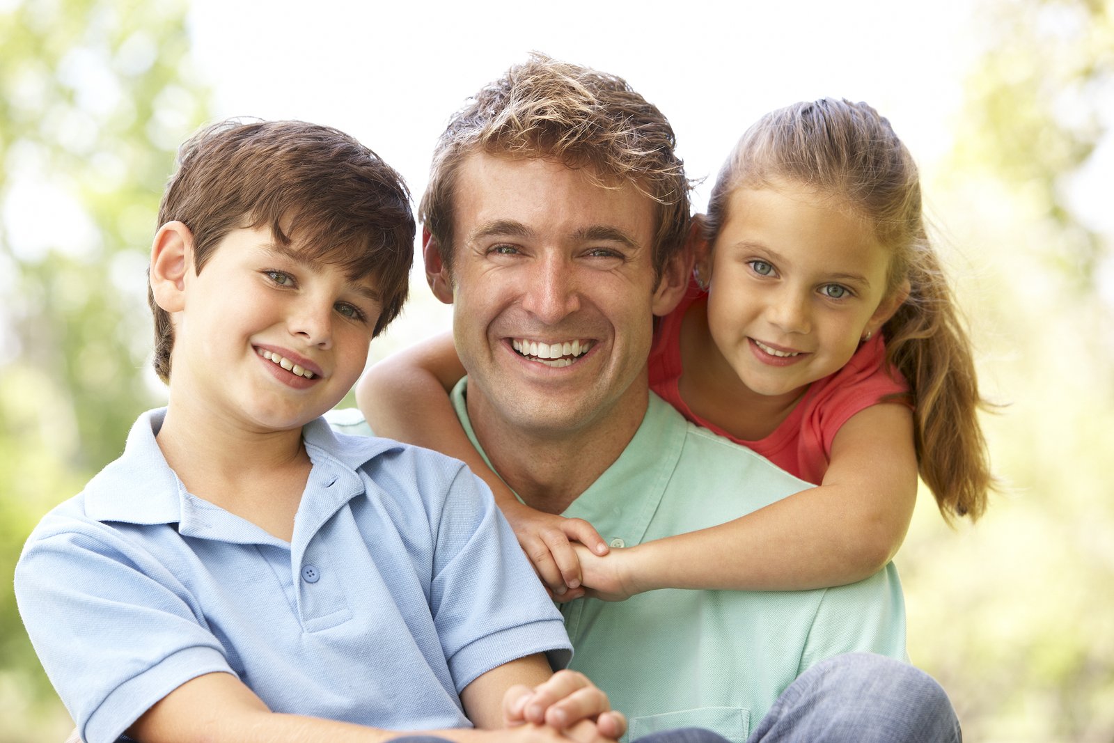 Father with children smiling outdoors